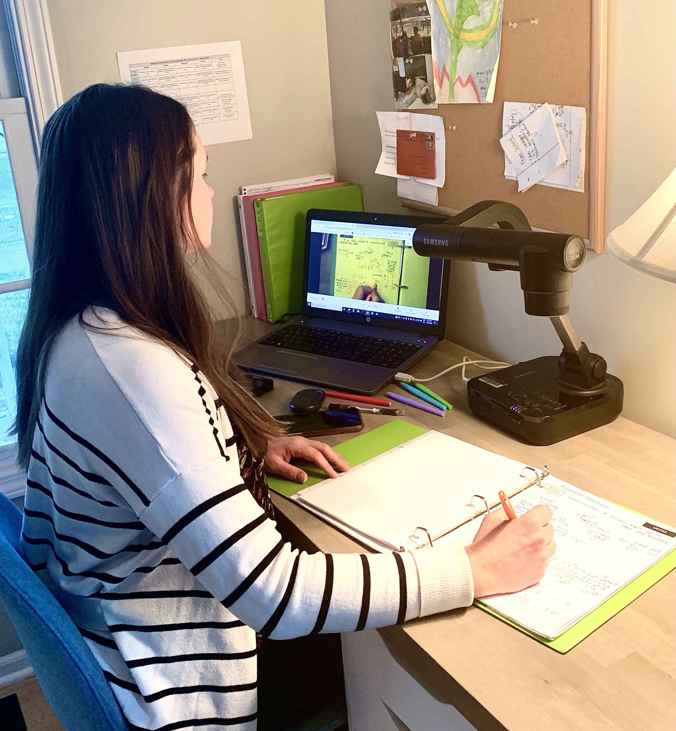 A teacher at Midland High School in Midland, Michigan, uses a document camera provided by Dow to share visuals in real-time with students.