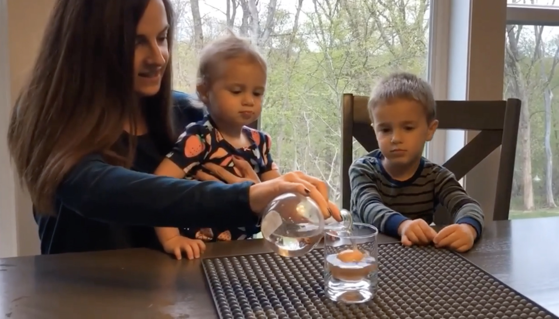 An engineer from the Flint Hills Resources Pine Bend refinery conducts a video experiment using an egg and vinegar to demonstrate a chemical reaction, part of a STEM at Home series on Facebook.